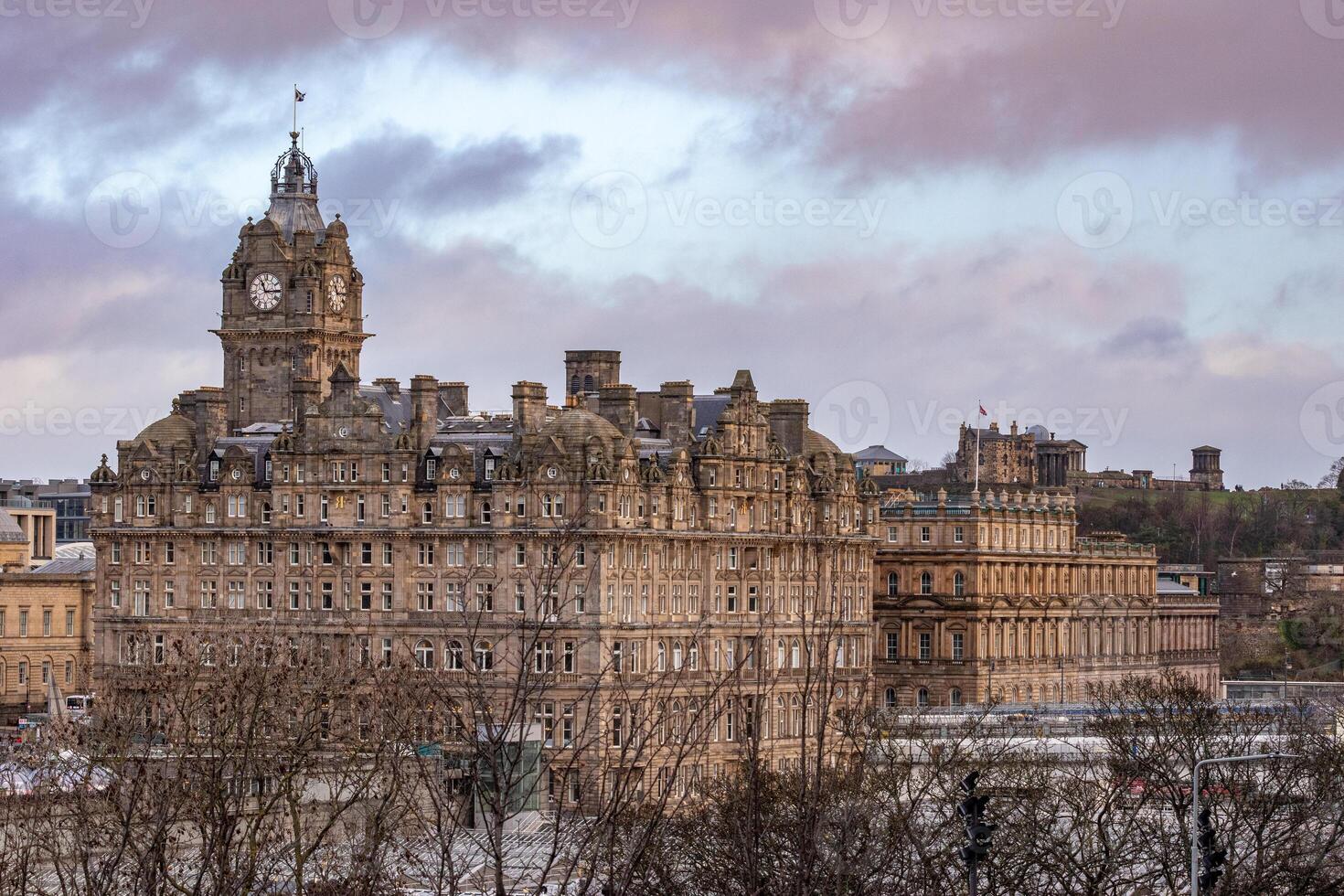 Historic building with clock tower against a cloudy sky at dusk, Edinburgh, Scotland. photo