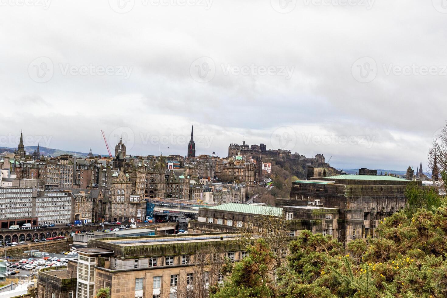 Panoramic view of Edinburgh cityscape with historic architecture and cloudy sky. photo
