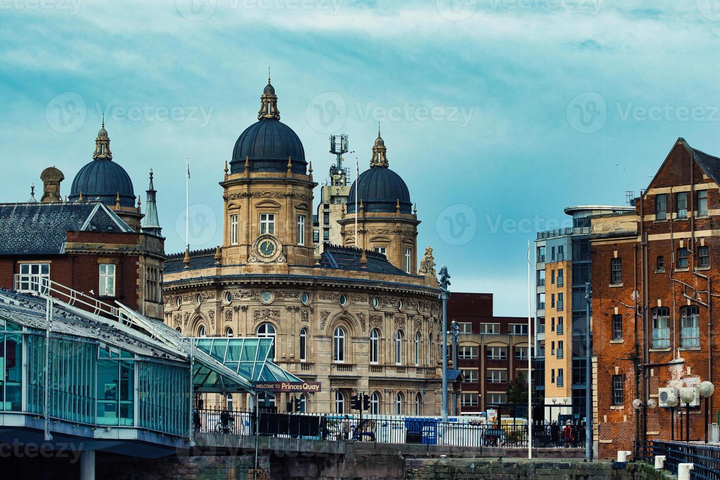 Historic European architecture with domed buildings and modern elements under a cloudy sky. photo