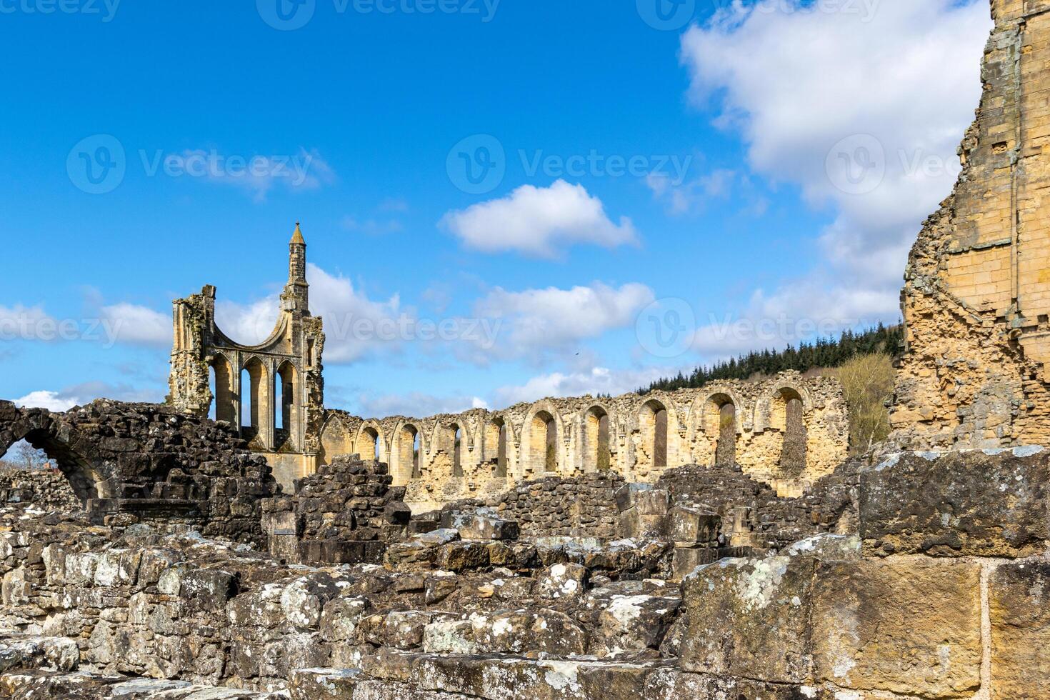 Ancient ruins under blue sky with clouds, historical architecture with arches and columns in Yorkshire. photo