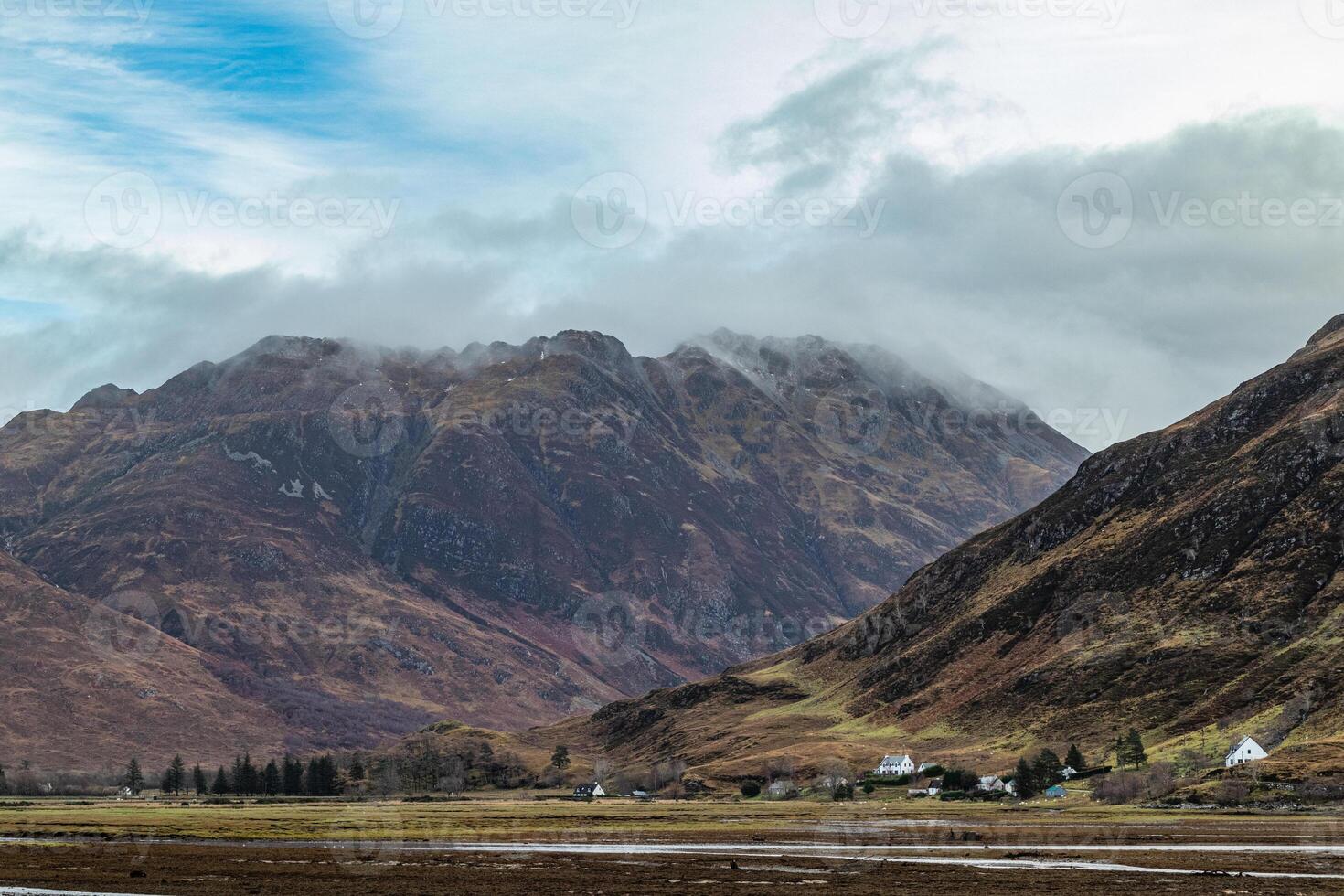 Scenic view of the Scottish mountains in the mist during the winter photo