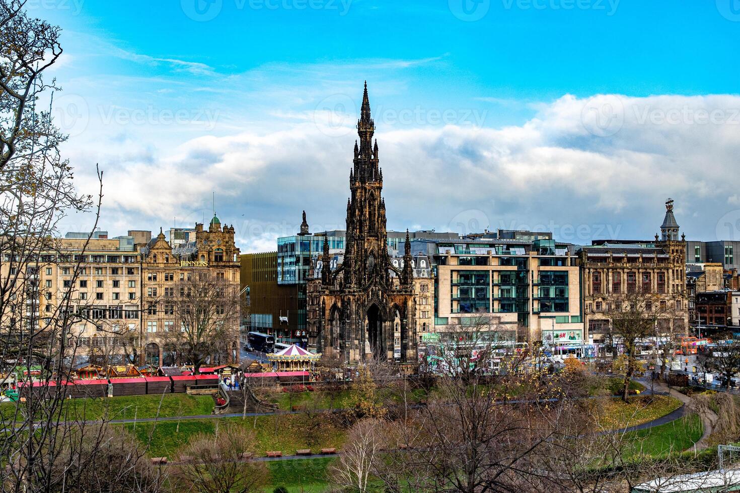 Panoramic view of Edinburgh cityscape with the Scott Monument and historical buildings under a cloudy sky. photo
