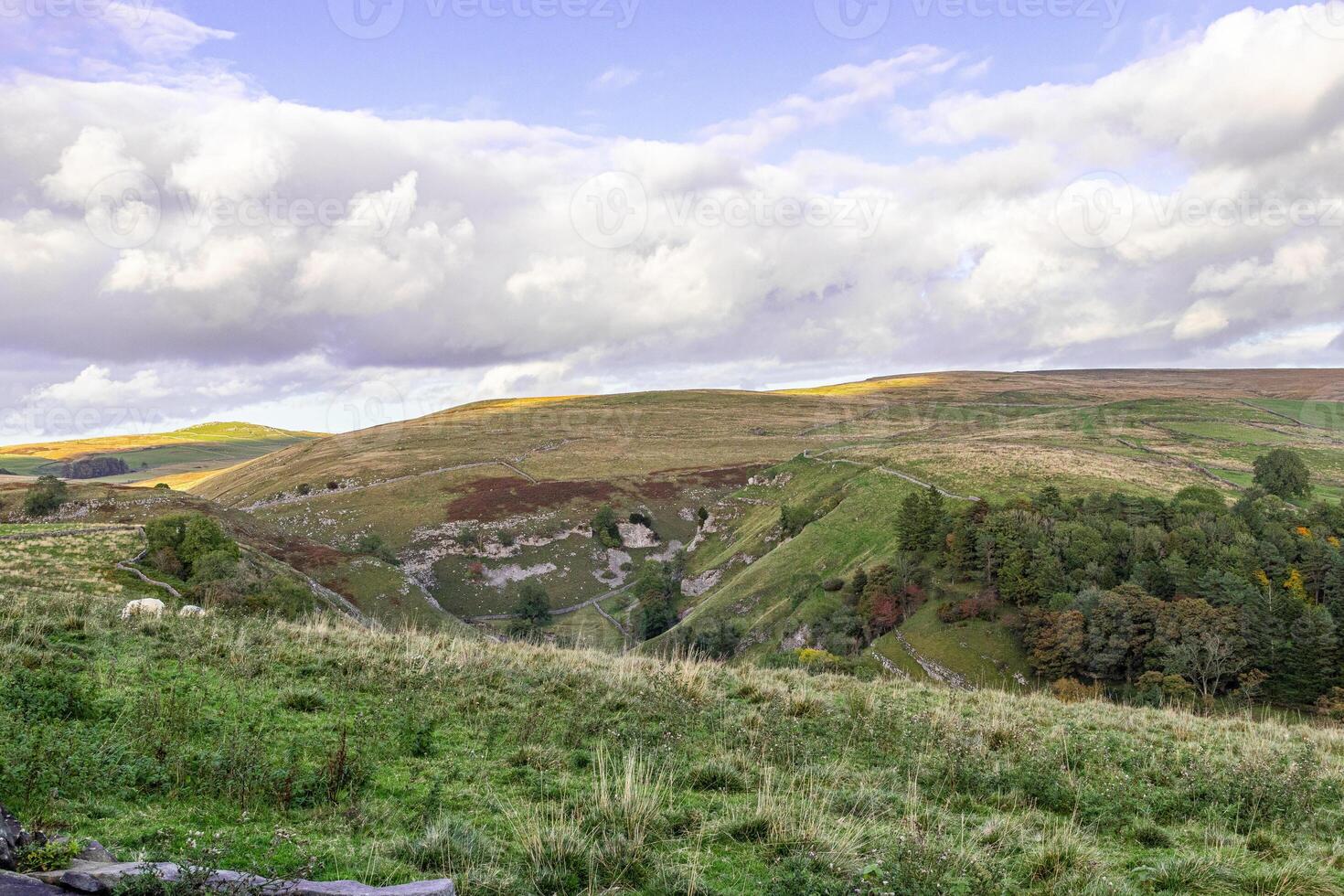 Scenic landscape photo in Yorkshire Dales with clouds over the hills