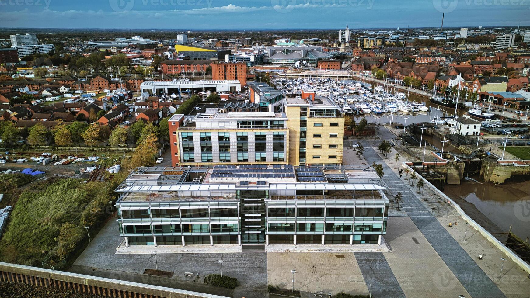 Aerial view of a modern office building in an urban landscape with parking and surrounding infrastructure in Hull, England. photo
