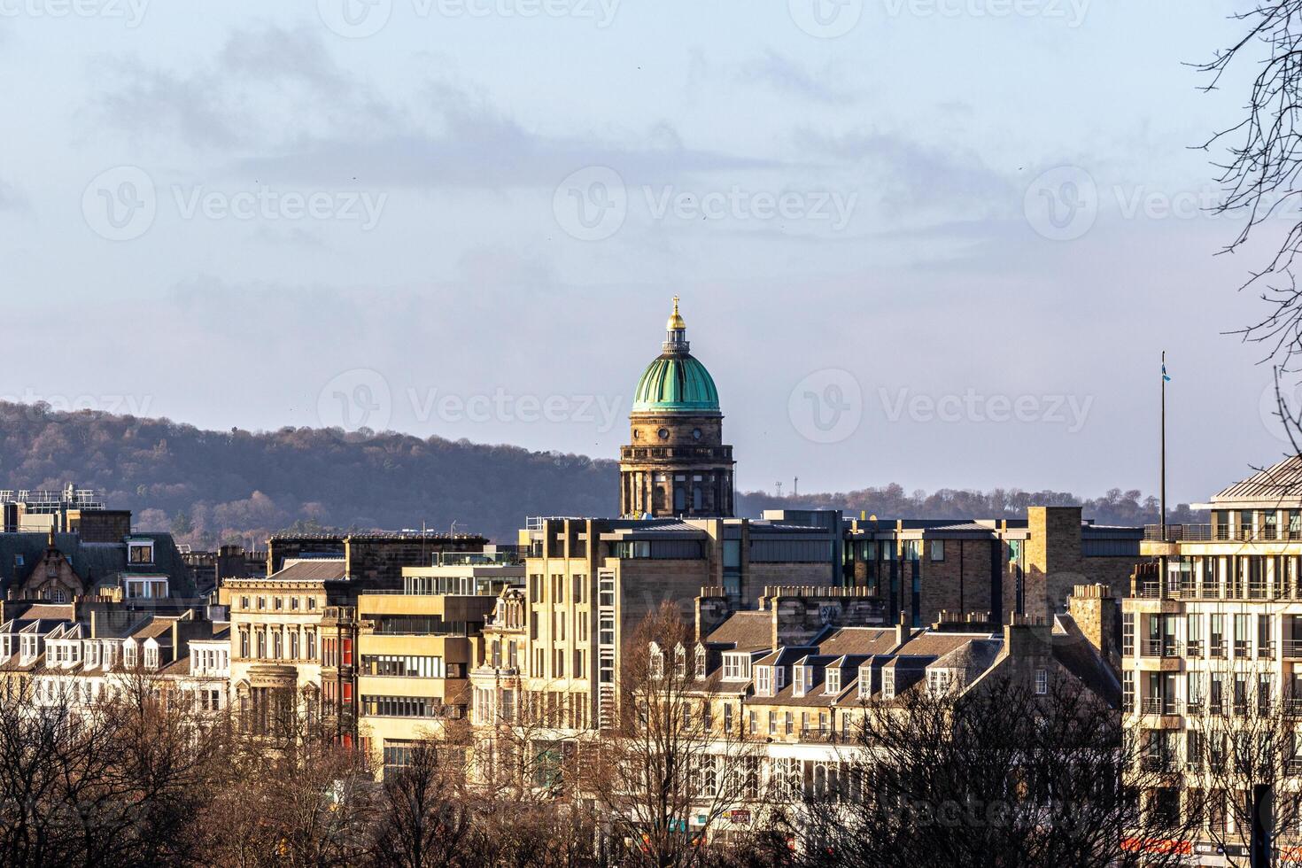 Cityscape with historic buildings and a prominent dome under a clear sky, showcasing urban architecture in Edinburgh, Scotland. photo