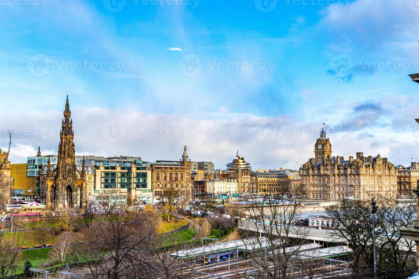 Panoramic view of a historic cityscape with a prominent monument and classical architecture under a blue sky with clouds. photo