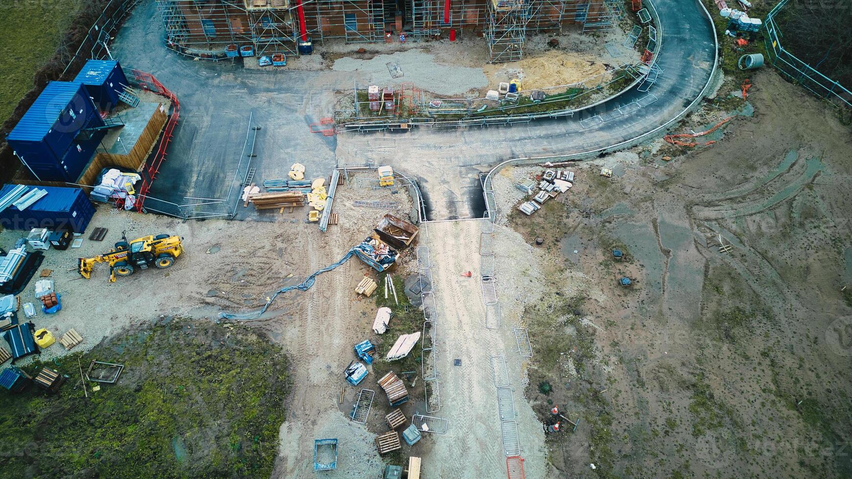 Aerial view of a construction site with heavy machinery and building materials. photo