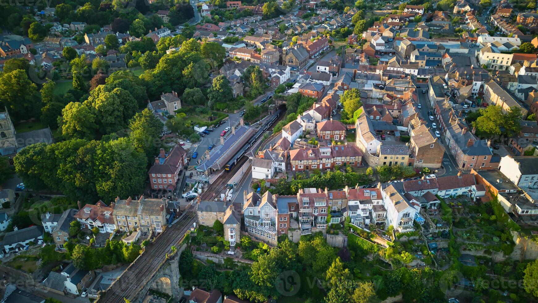 Aerial view of a quaint European town with historic buildings and lush greenery, showcasing the charming urban landscape in Knaresborough, North Yorkshire. photo