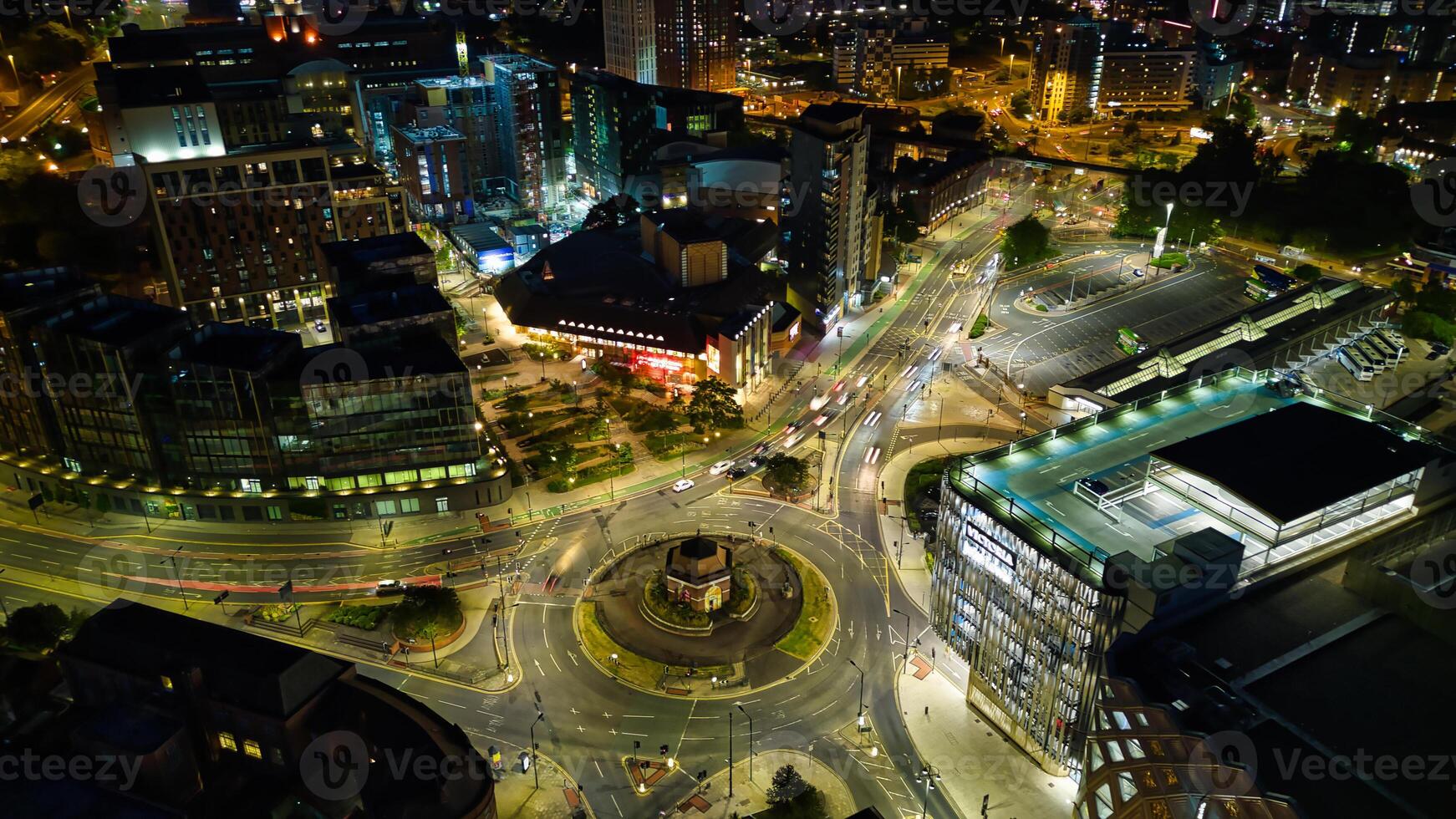 Aerial night view of a cityscape with illuminated streets and roundabout, showcasing urban traffic and architecture in Leeds. photo