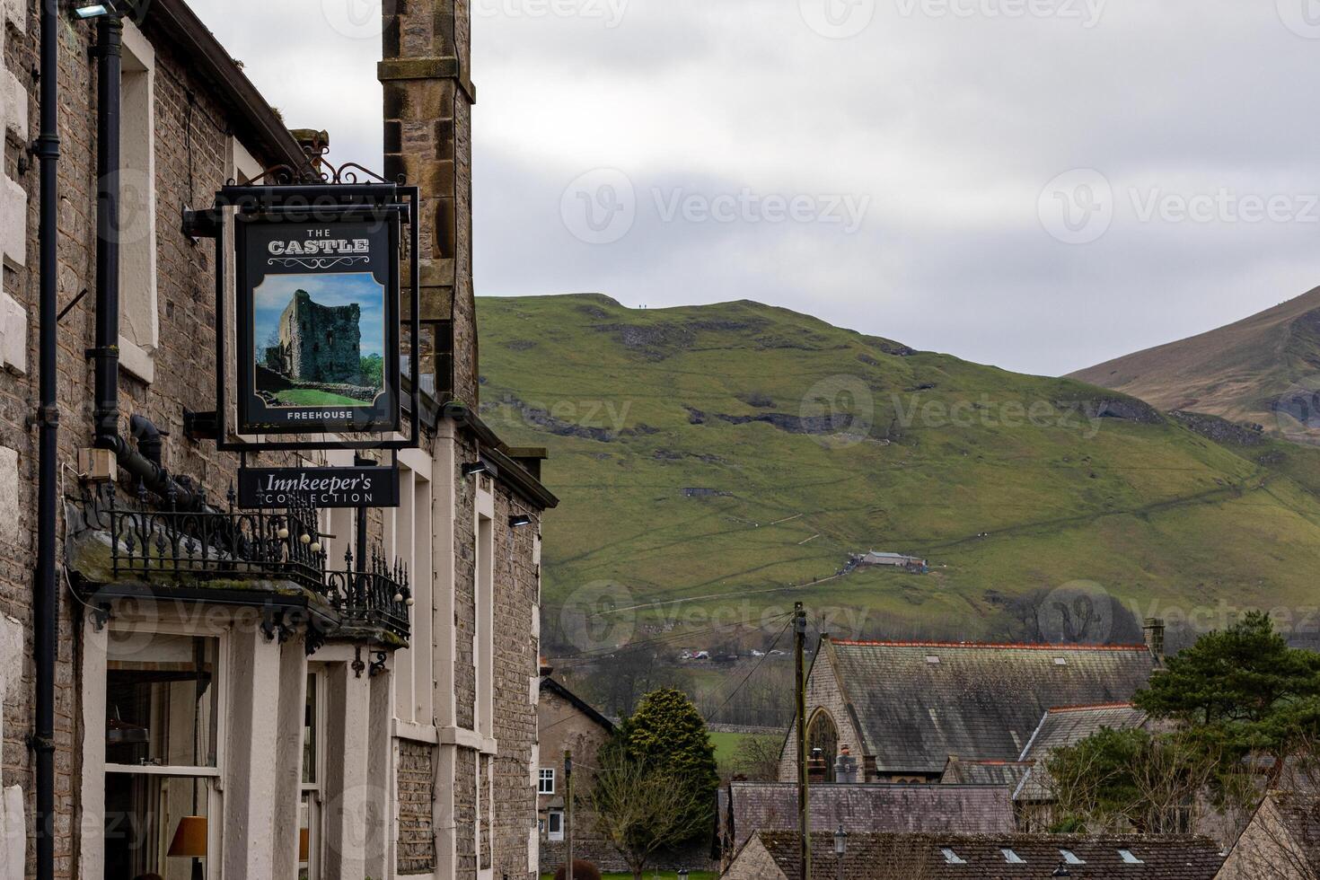 Quaint British pub sign with rolling hills in the background, capturing the essence of rural UK. photo