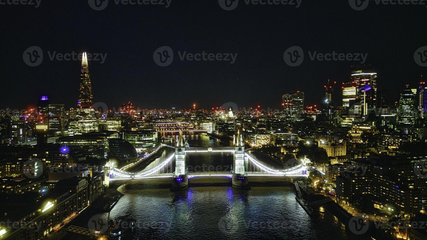 Scenic aerial view of the Tower Bridge and city at night in London photo