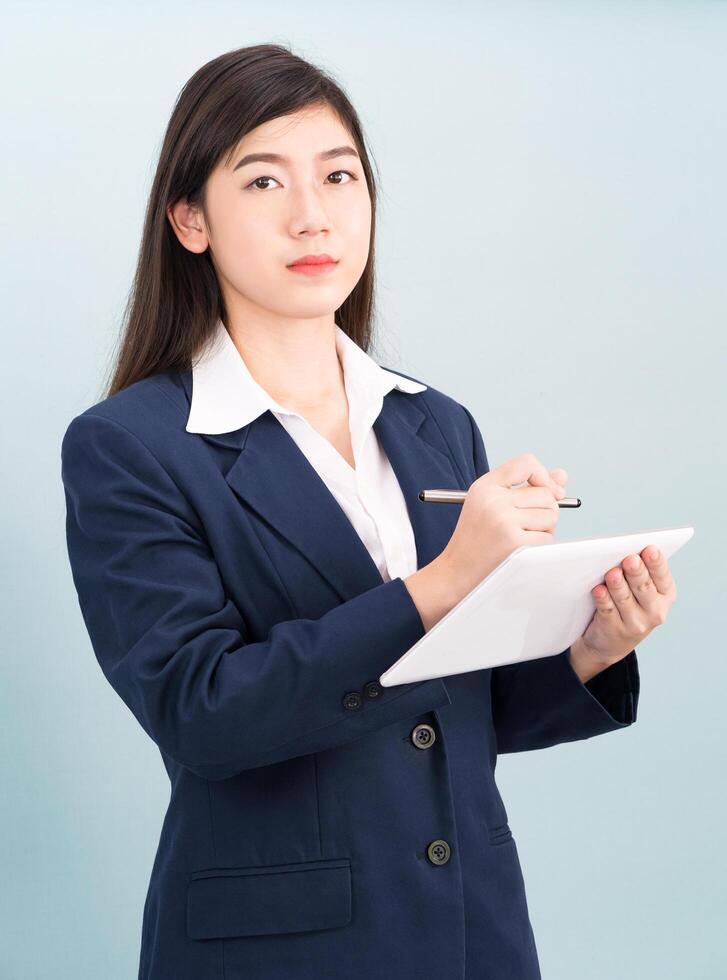 Teenage girl in suit using computer digital tablet photo