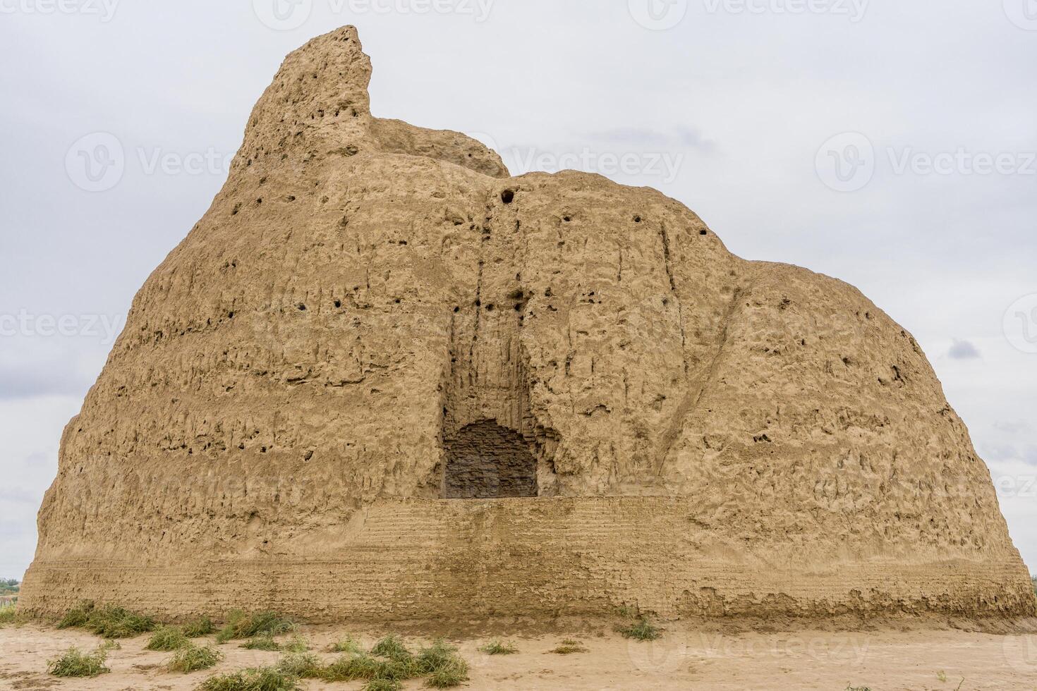 An ancient ice chamber build from clay used as refrigerator in Old Merv, Mary, Turkmenistan on a clouded background photo
