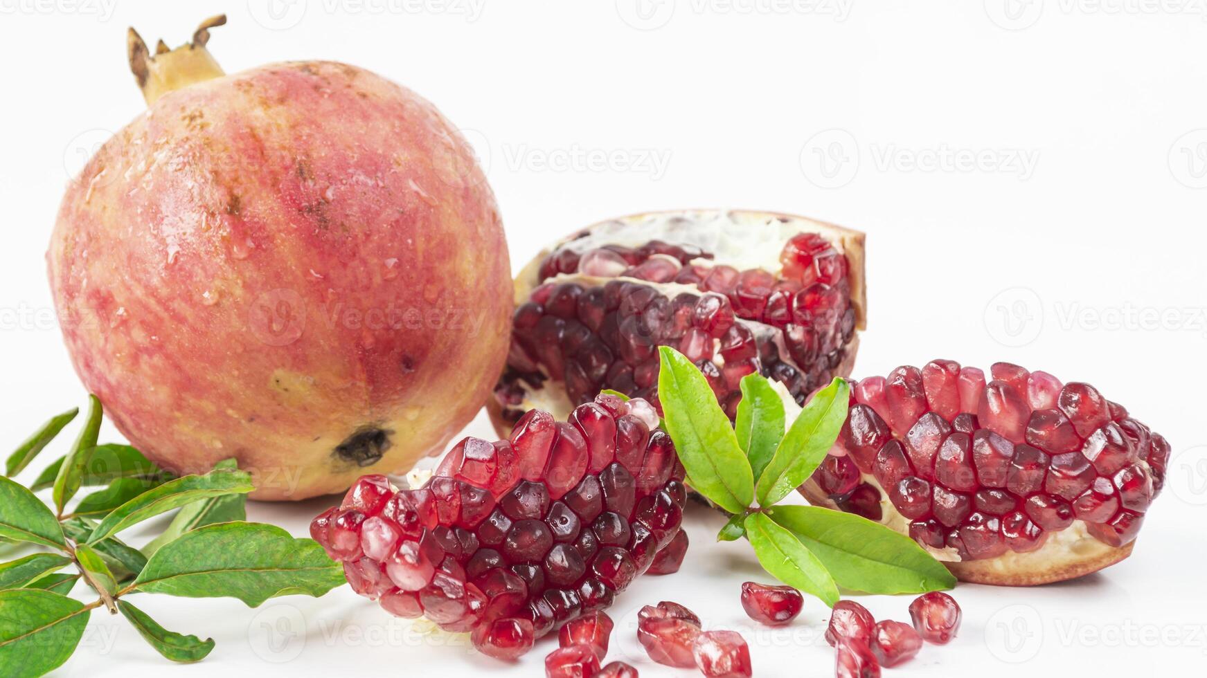 pomegranate with leaves and seeds photo