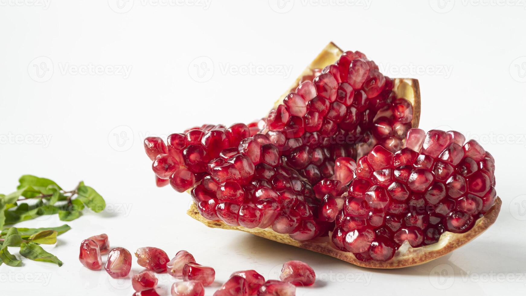 a pomegranate is cut in half and surrounded by leaves photo