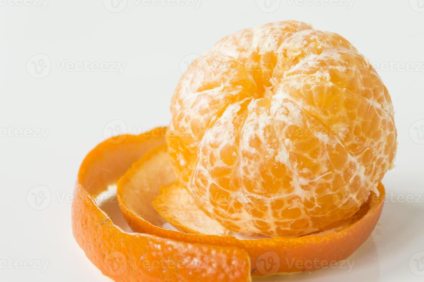 a peeled orange on a white surface photo