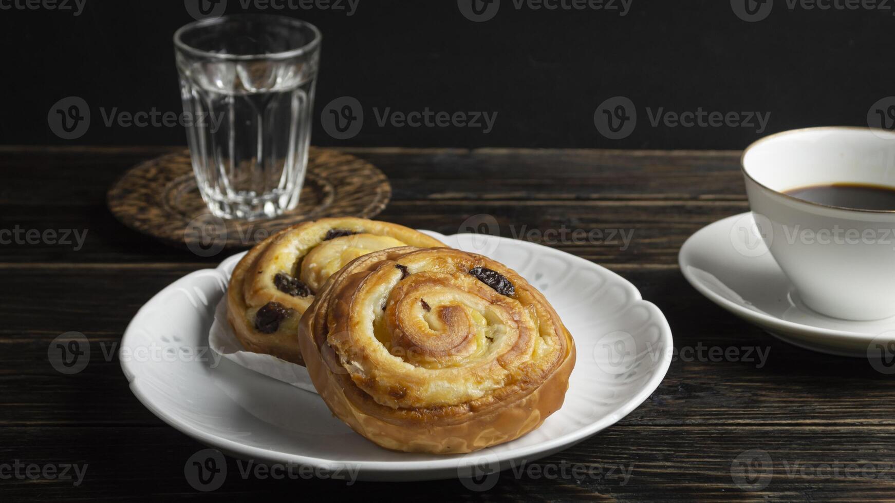 a plate with cinnamon roll and a cup of coffee photo