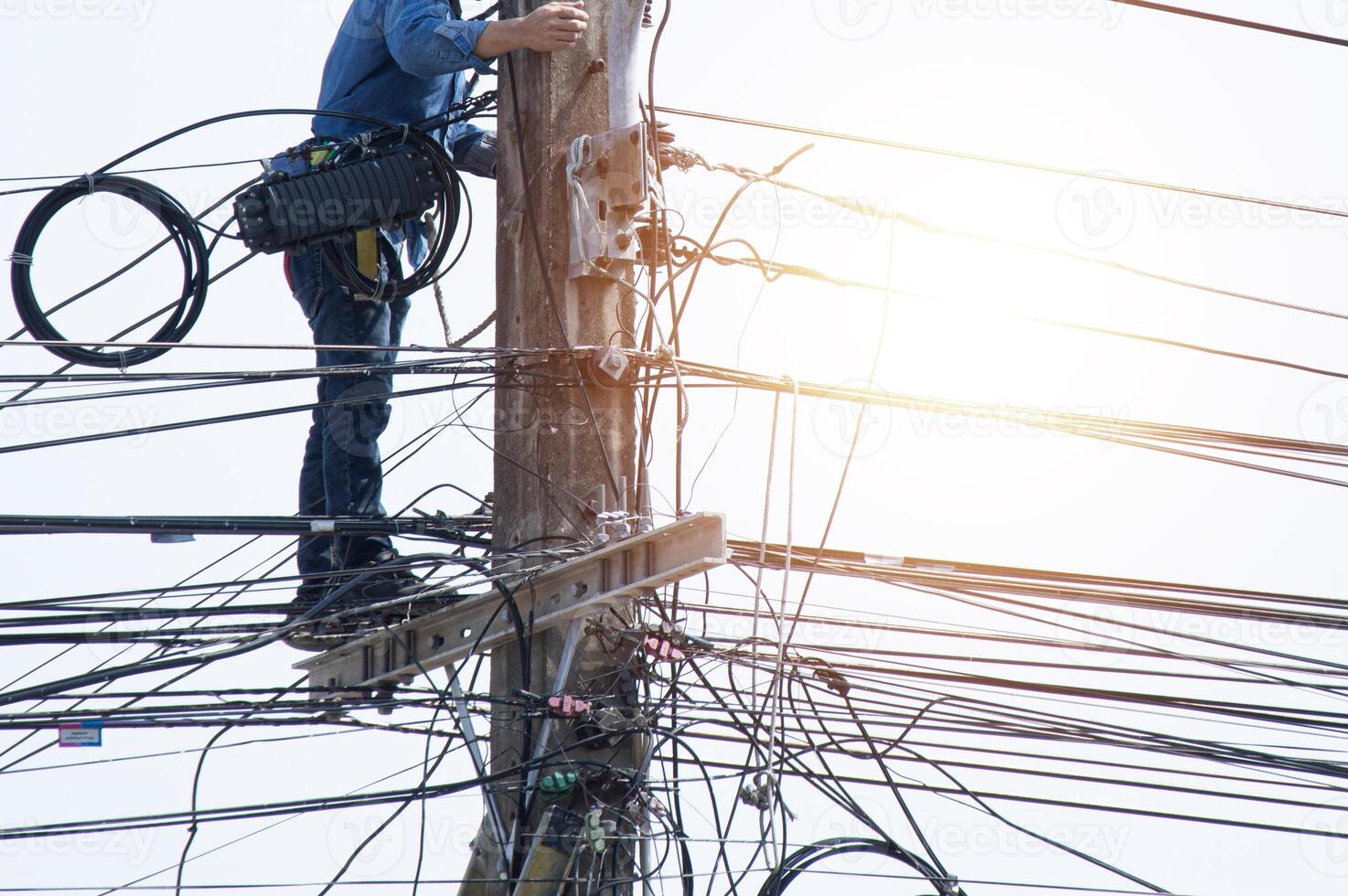 High voltage tower work for installing wires and equipment photo