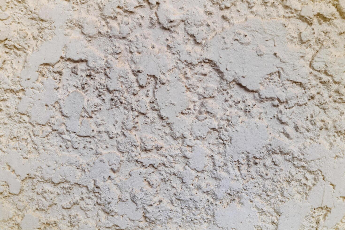 Rough and chunk surface white cement wall with vignette. photo