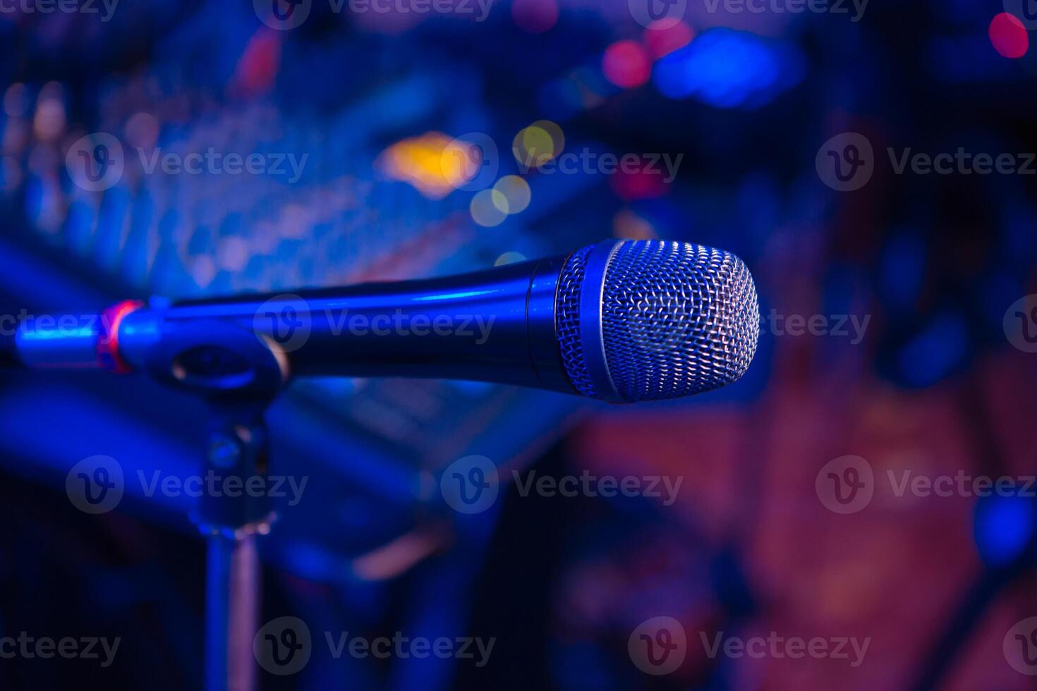 microphone stands in the holder at a concert in the restaurant. Close-up. Blurred blue background photo