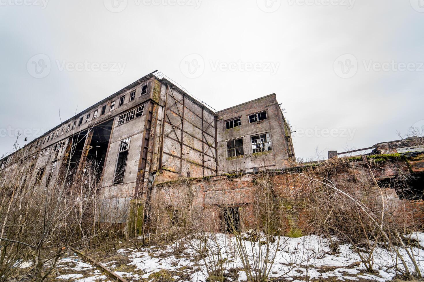 Destroyed abandoned factory after the war, broken glass, destruction, frightening industrial composition photo