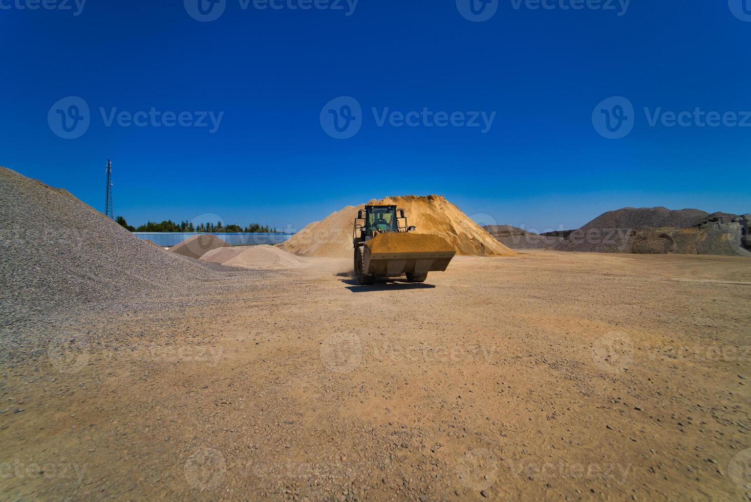 Quarry aggregate with heavy duty machinery. Construction industry. Horizontal photo