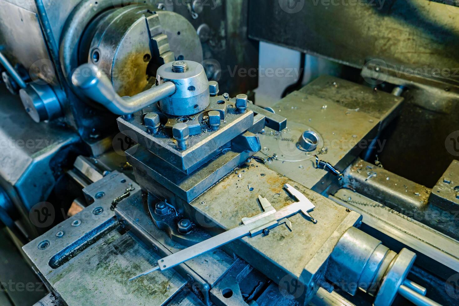 metal lathe processes metal parts on the production in the plant. The work process of the lathe. Close-up photo