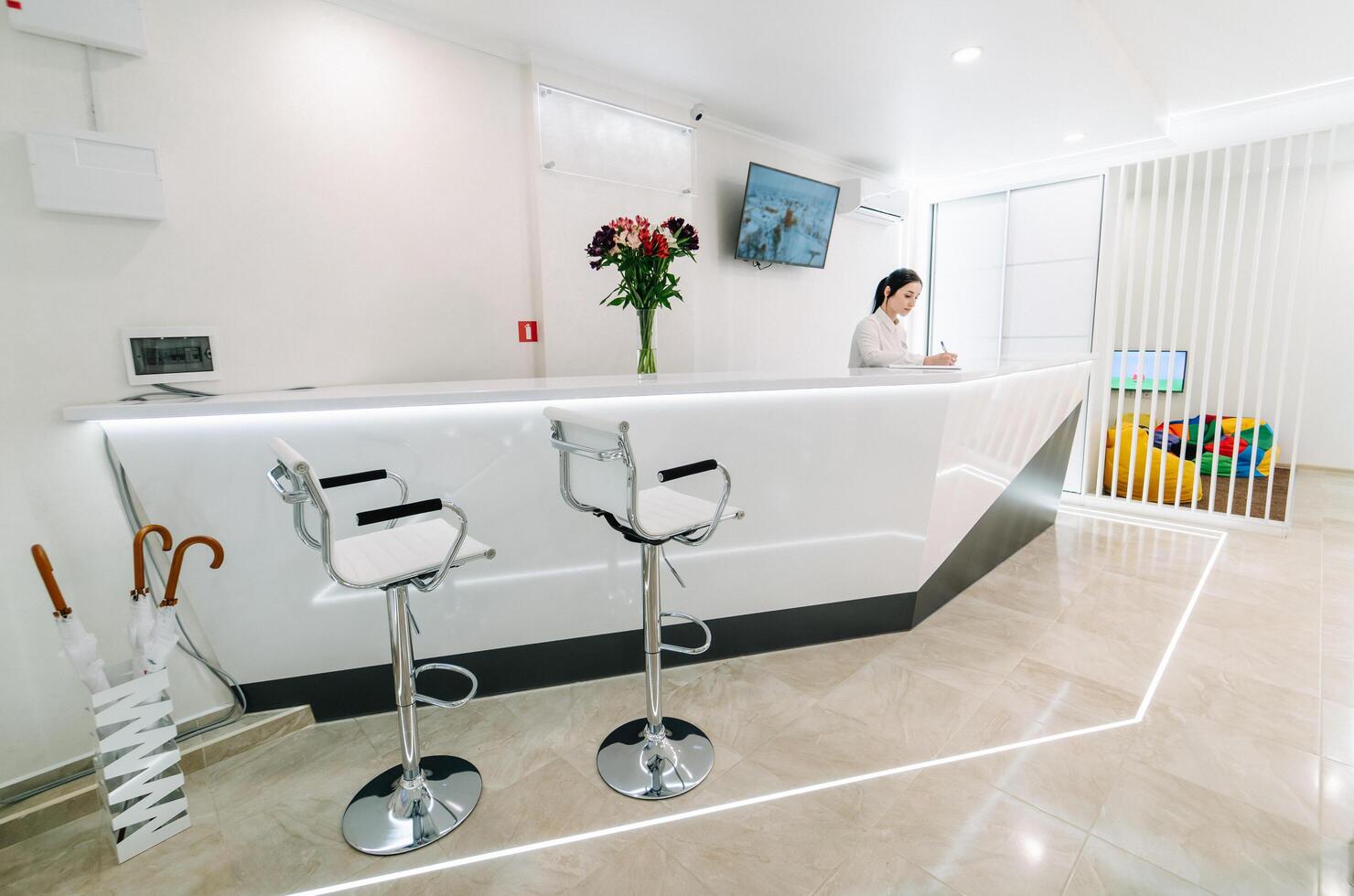 Reception area at the dental clinic. The workplace is a table with a computer. photo