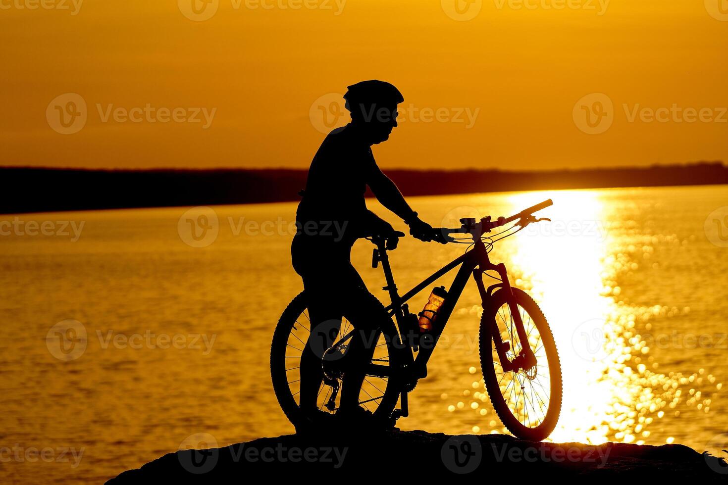 Man cycling at beach on twilight summer season. Active Lifestyle Concept photo