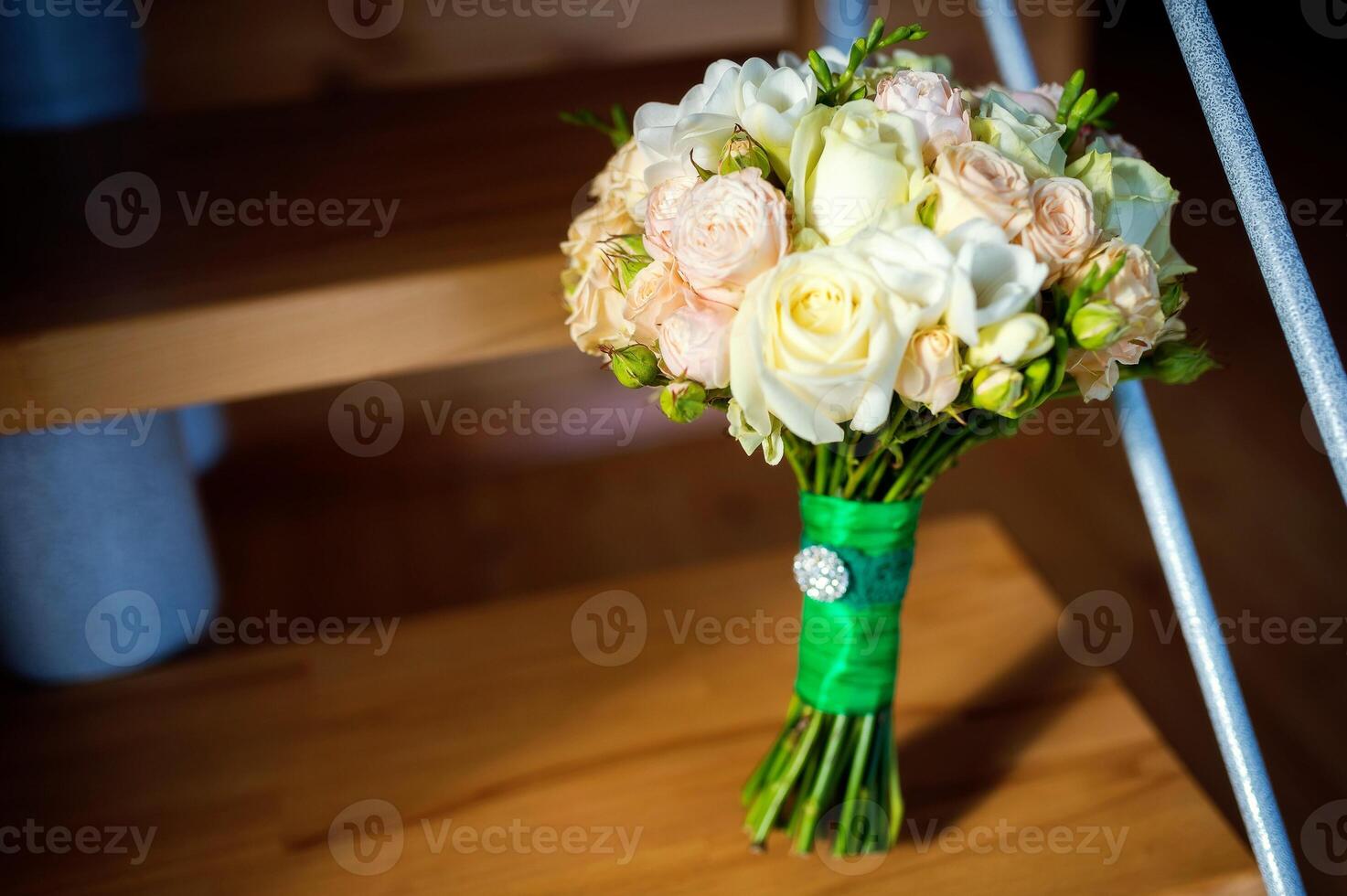 Beautiful wedding bouquet with white and pink roses for bride. Bunch of florets on the wooden surface. Female decoration for girl. Close-up photo