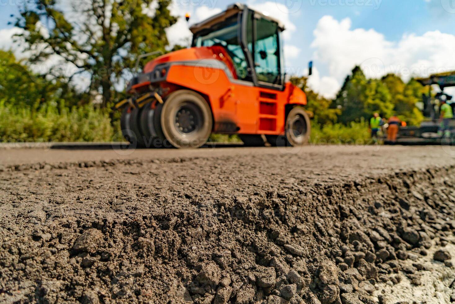 Roller at asphalt pavement works. Roller during road construction at asphalting work photo