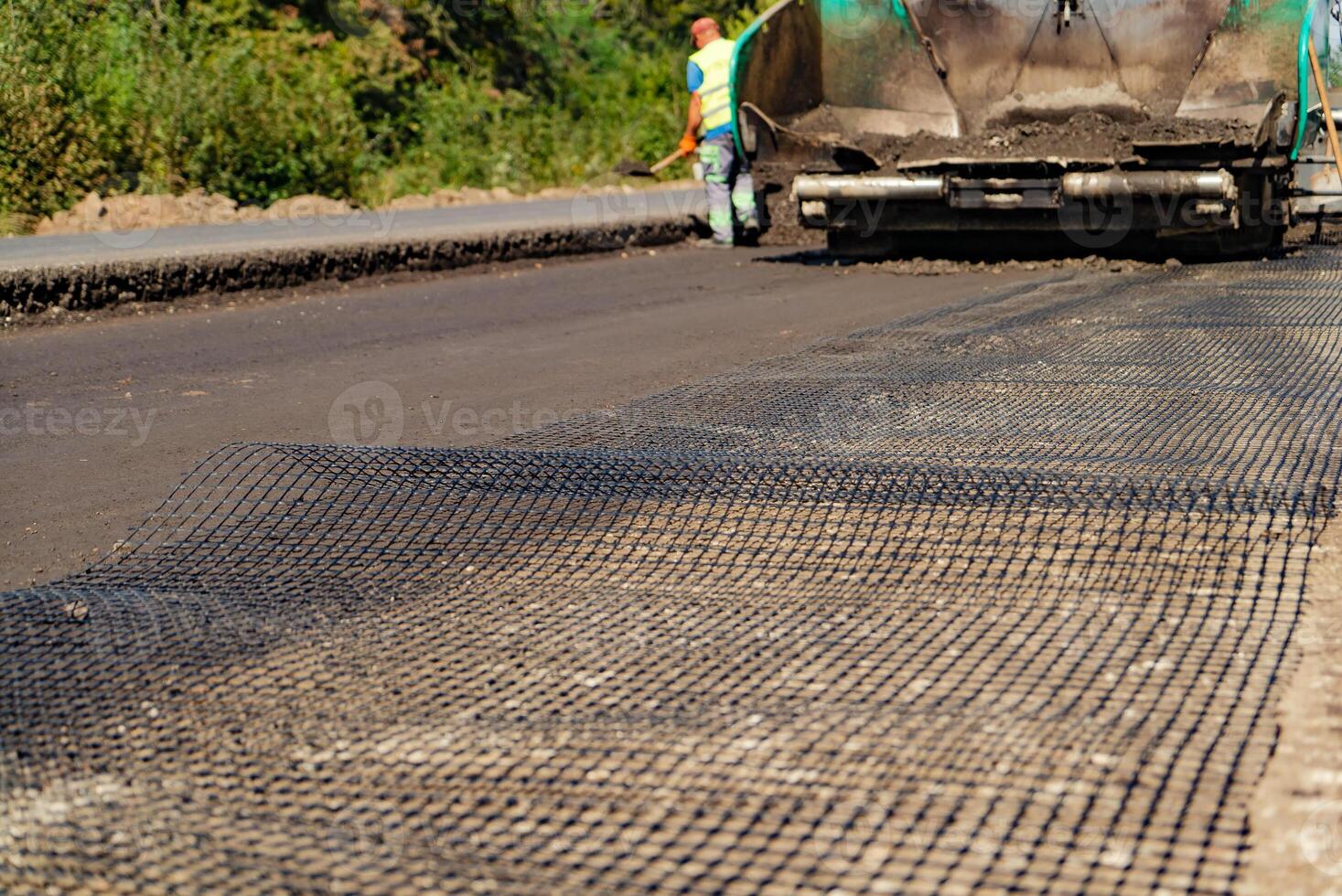 reinforced mesh laid out on the road by workers in the process of construction and repair works of roads photo