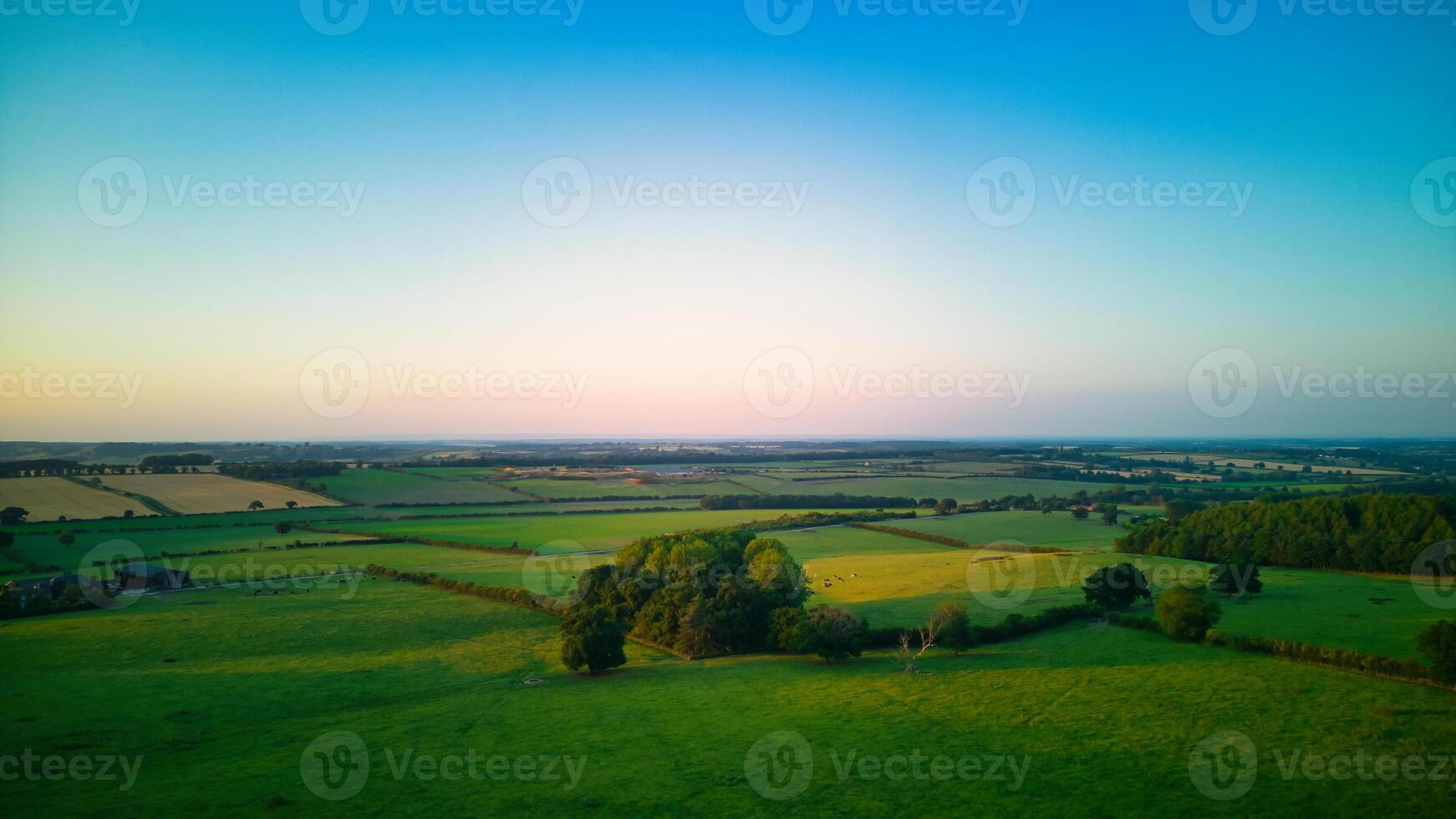 Serene landscape at dusk with lush green fields and a clear horizon under a soft gradient sky in Yorkshire. photo