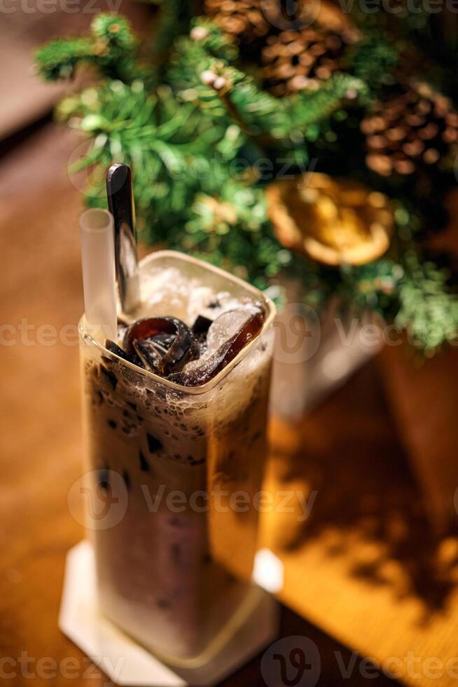 Ice chocolate in glass cups. Dark background with garland lights bokeh. Christmas and New Year sweet dfink and food holiday concept photo