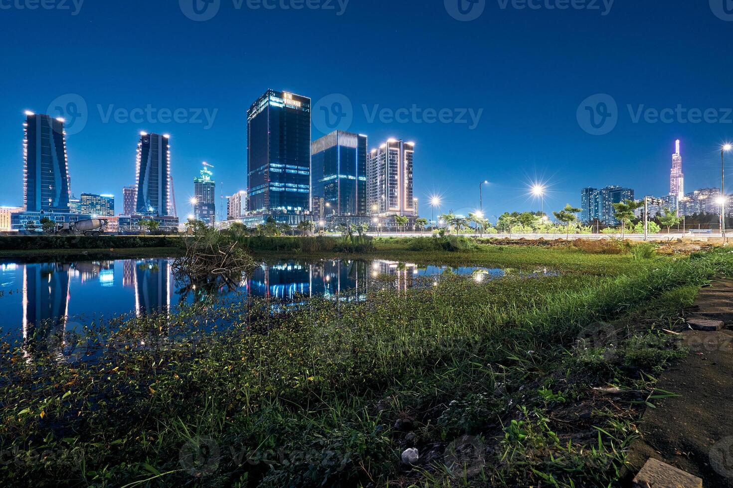 Ho Chi Minh City skyline and the Saigon River. Amazing colorful night view of skyscraper and other modern buildings at downtown photo