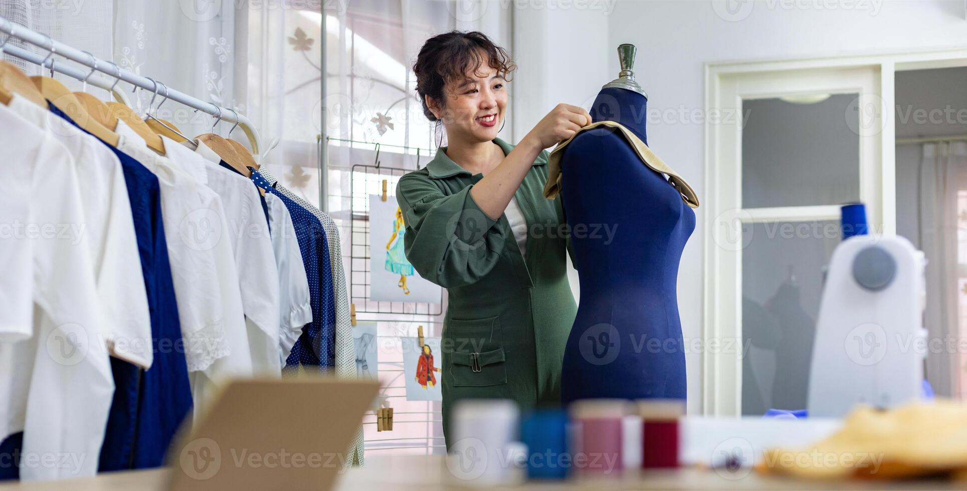 Fashionable freelance dressmaker is pinning her marking collar for new dress by pinning to mannequin while working in her artistic workshop studio for fashion design and clothing business industry photo