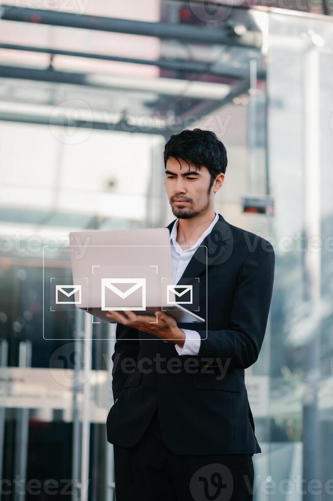 Woman hands using Laptop, tablet typing on keyboard and surfing the internet with email icon, email marketing concept, send e-mail or newsletter, online working photo