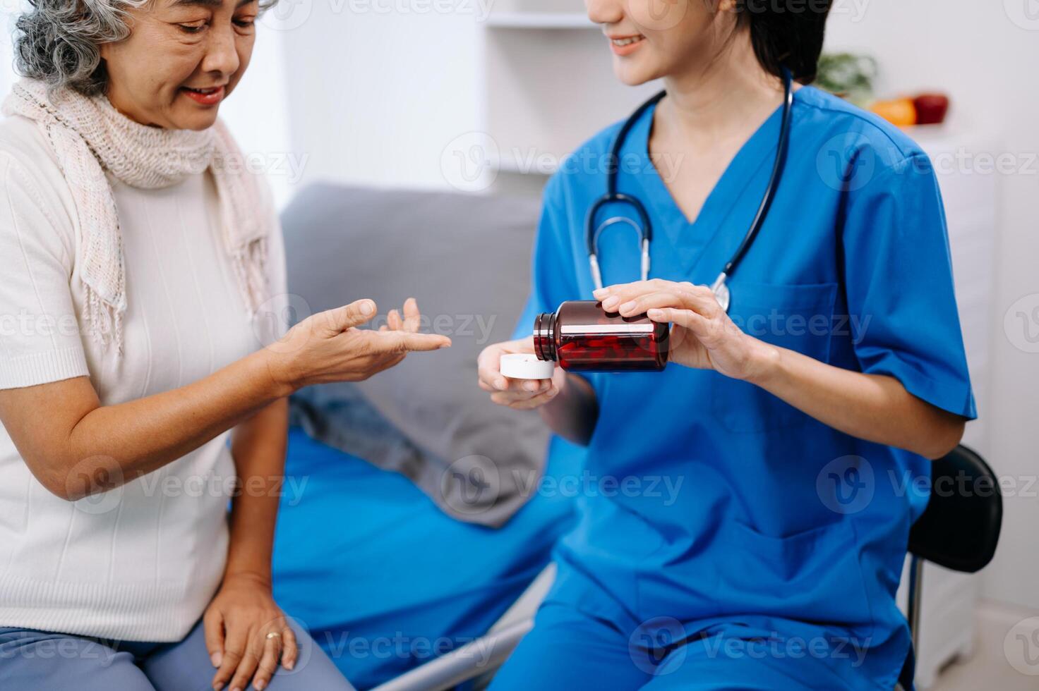 Doctor in white suit take notes while discussing and Asian elderly, woman patient who lying on bed with receiving saline solution photo