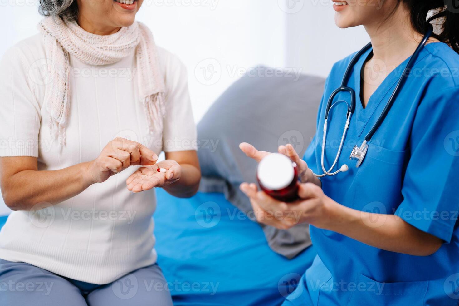 Doctor in white suit take notes while discussing and Asian elderly, woman patient who lying on bed with receiving saline solution photo