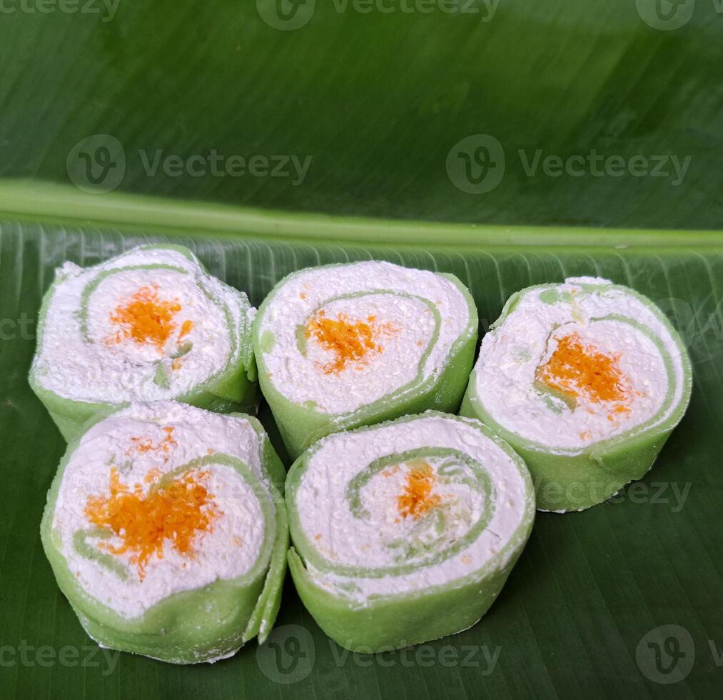 Foi Thong face cream roll placed on a banana leaf photo