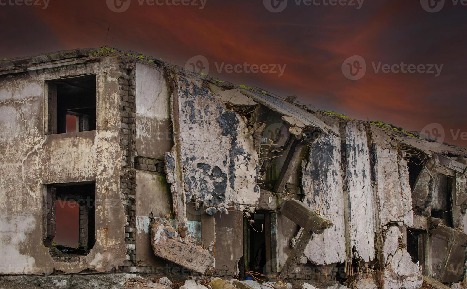 Ruins of a building against a red dark sky background photo