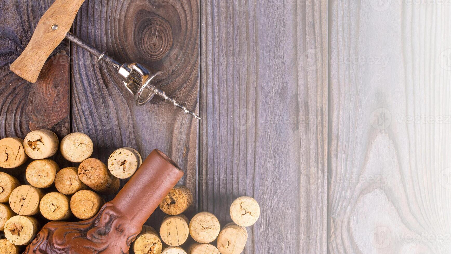 Bottle of wine with corks on wooden table background. on soft sunlight photo