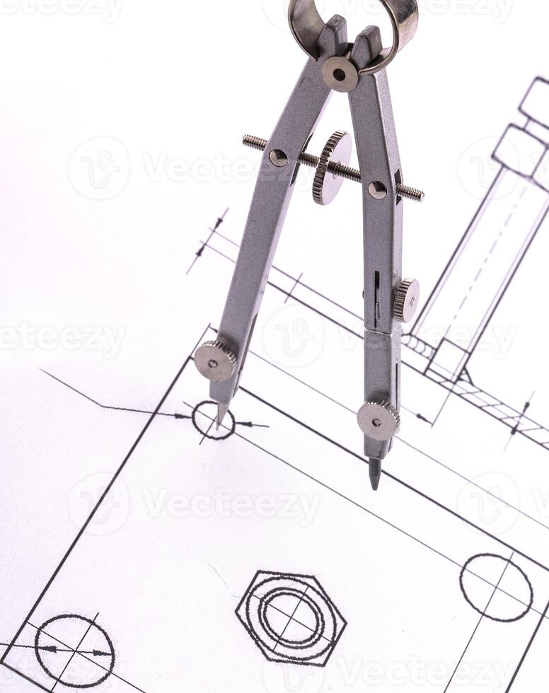 Architect working on a blueprint, close up on hand and blueprint photo