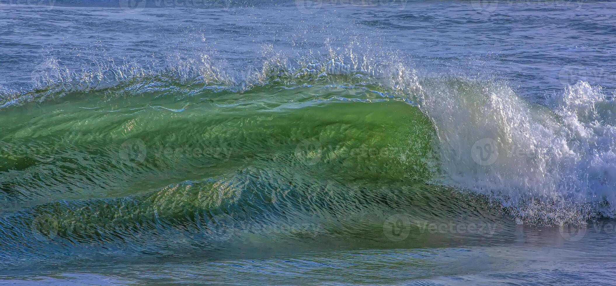 Sea or ocean, waves close-up view. Green - yellow waves sea water. Crystal clear water photo