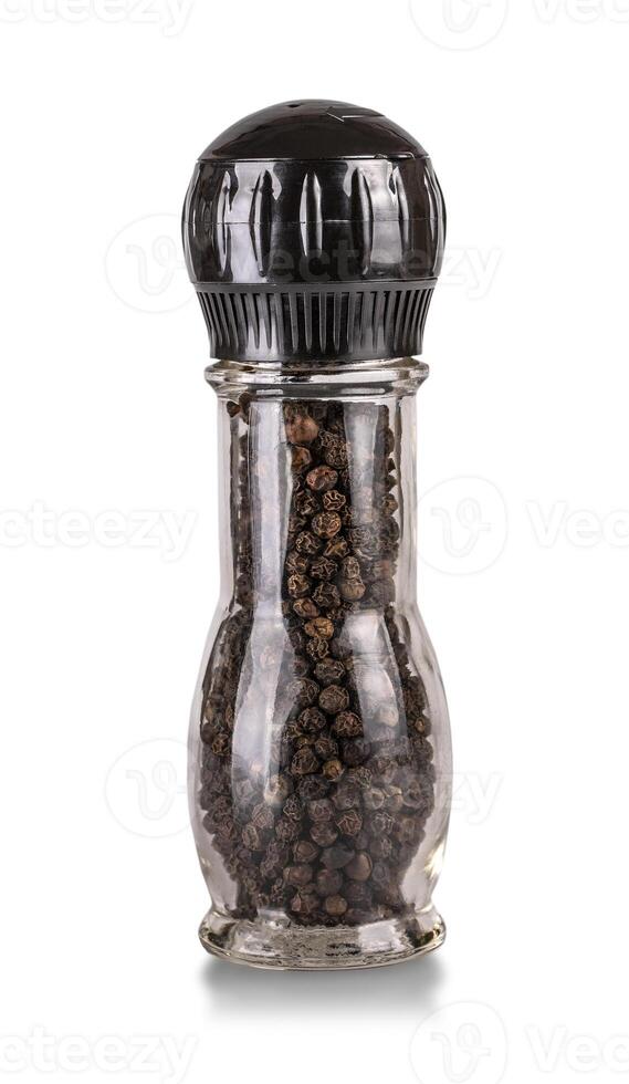 Close up of bottle with pepper in containers with grinder prepared. photo