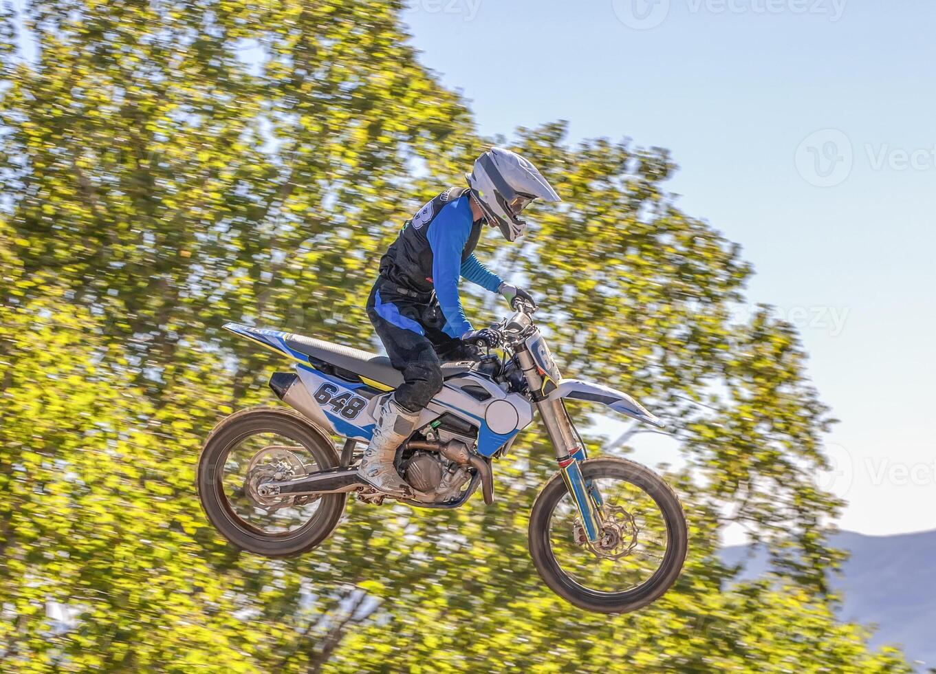 Extreme sports, motorcycle jumping. Motorcyclist makes an extreme jump photo