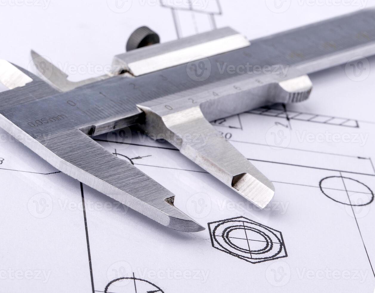 Old metal caliper and engineering drawing. Close up photo