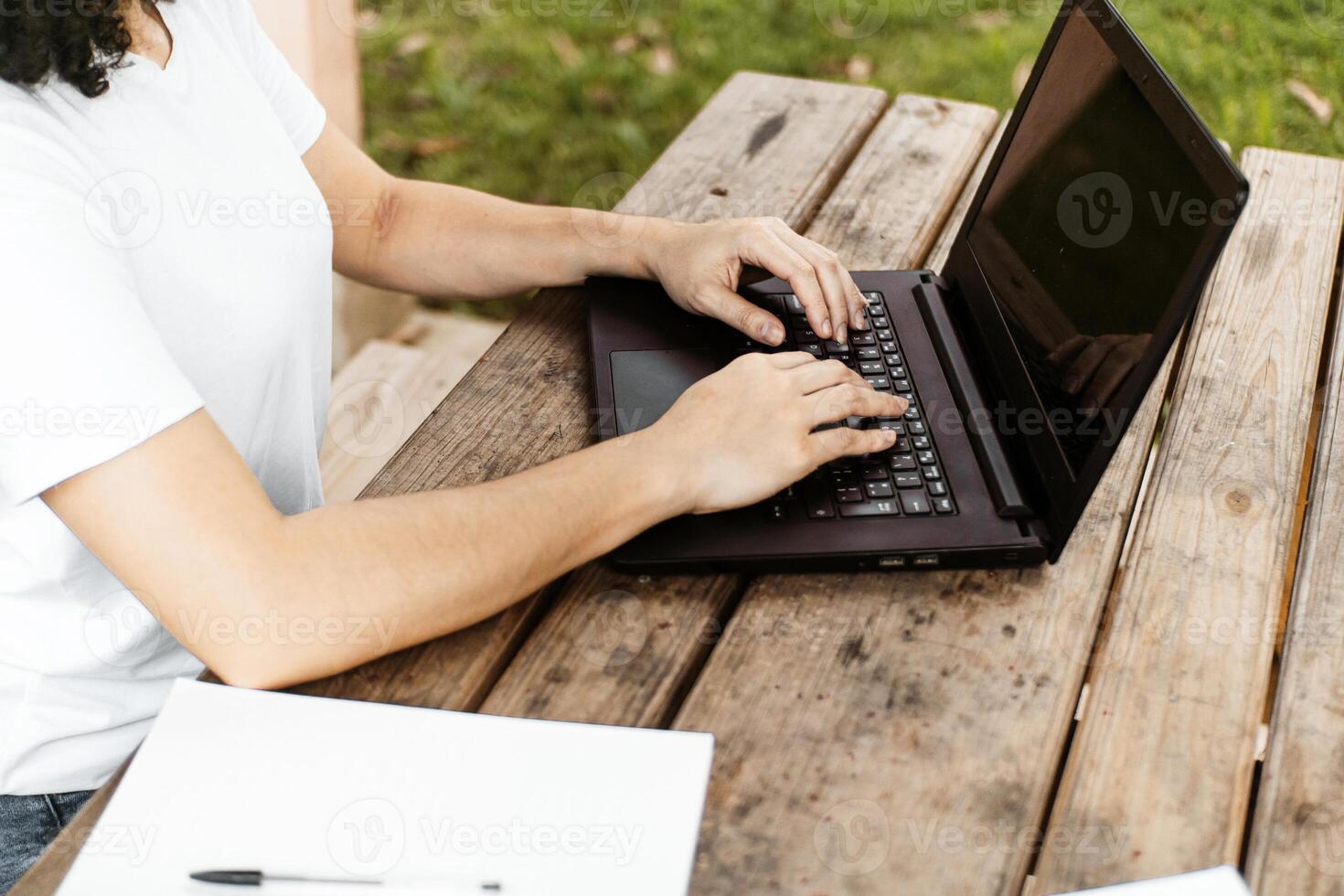 Hands of a Person Using a Laptop Computer. photo