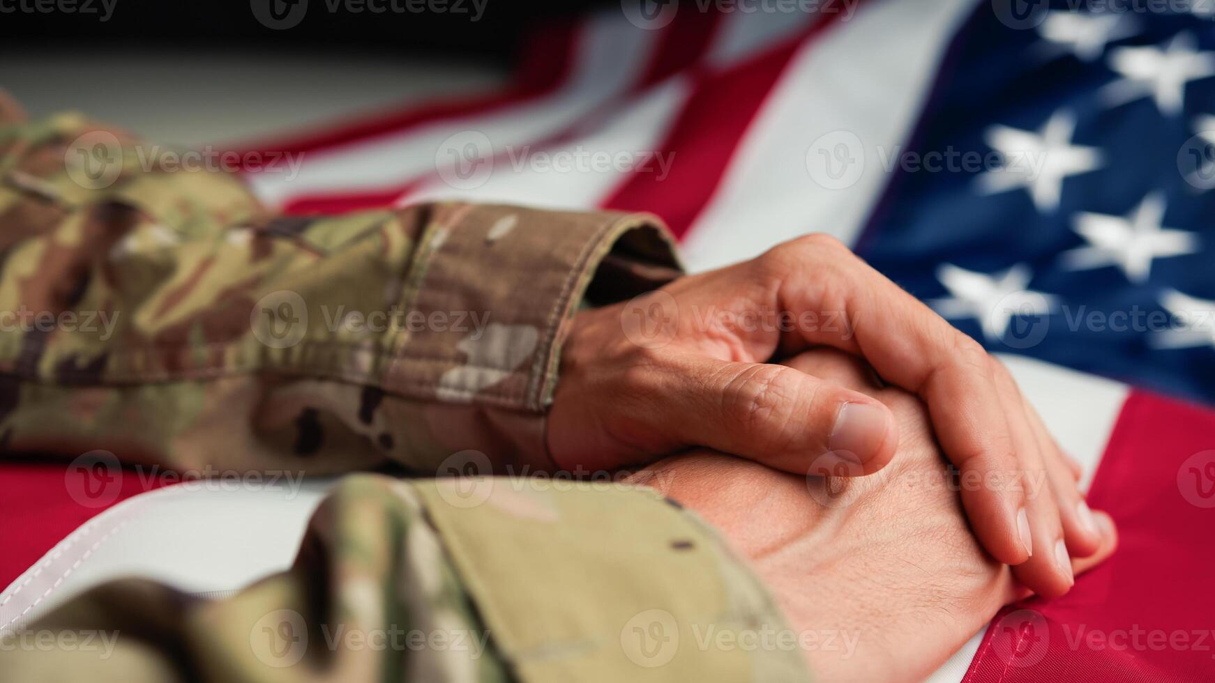 Military man in Uniform touching USA flag with his hand photo