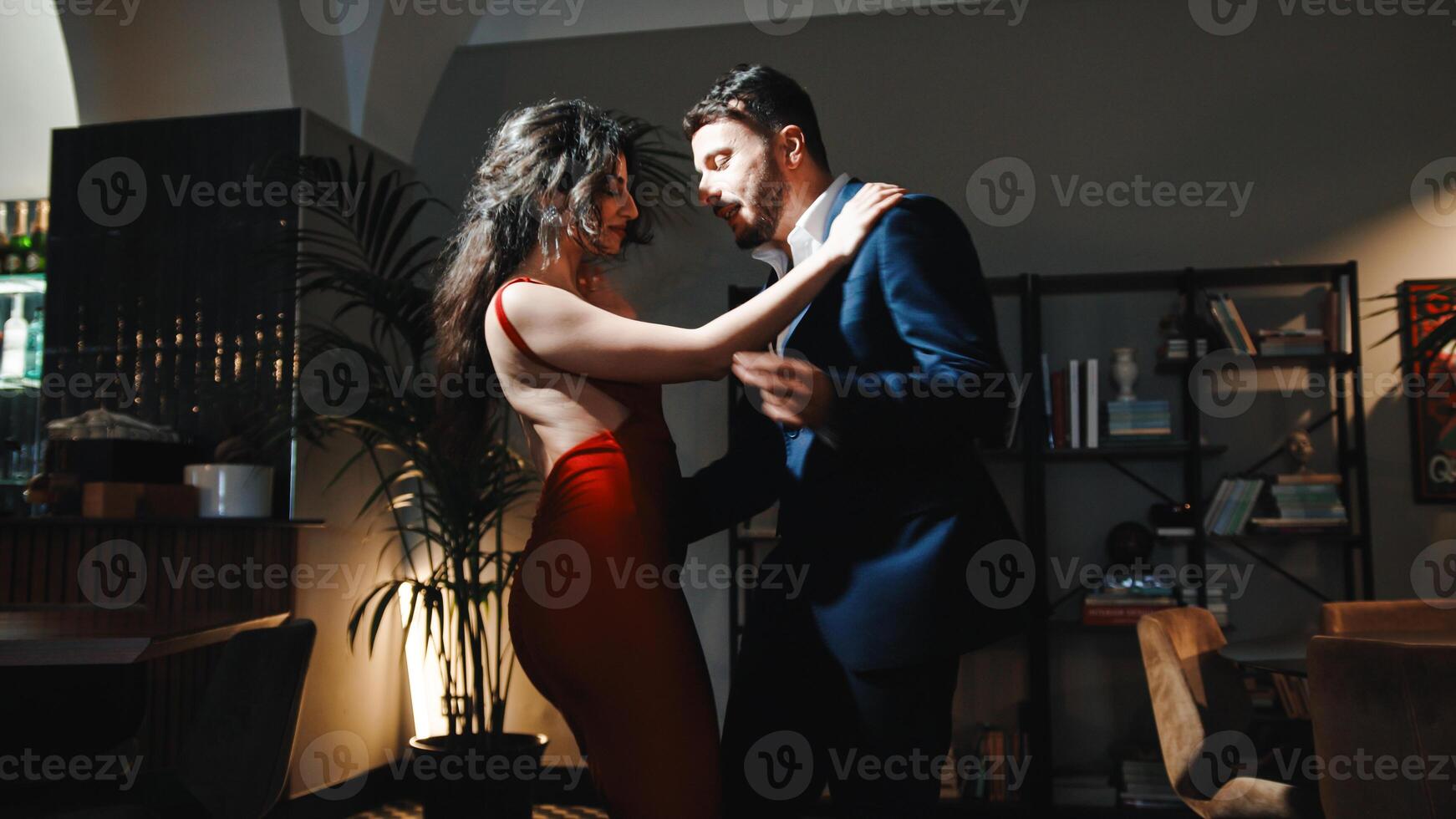 Couple dancing on living room photo